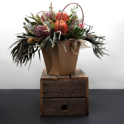 Mixture of beautiful Australian Natives, Gum Leaves, and Banksias with luscious foliage and leaves. Available in 3 sizes small, medium, and large. Presented in our exquisite bag arrangement.